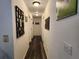 Hallway featuring wood floors and white walls at 120 Fisher Ct, Ocklawaha, FL 32179