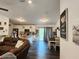 Open concept living room featuring vinyl floors, modern lighting and a view of the kitchen at 120 Fisher Ct, Ocklawaha, FL 32179