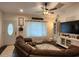 Cozy living room featuring a large sectional sofa, a ceiling fan, and a decorative rug at 120 Fisher Ct, Ocklawaha, FL 32179