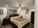 Bedroom with ceiling fan, neutral walls, and dark wood furniture at 120 Fisher Ct, Ocklawaha, FL 32179