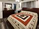 Bedroom with dark wood furniture and stylish quilt at 120 Fisher Ct, Ocklawaha, FL 32179