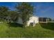 Backyard with grass, foliage, and air conditioner at 1228 Maria Ct, Lady Lake, FL 32159