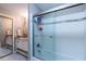 Bathroom features a double vanity and a glass door shower with a tile border at 1228 Maria Ct, Lady Lake, FL 32159