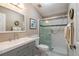 Well-lit bathroom featuring a shower with glass doors and a gray vanity with plenty of space at 1228 Maria Ct, Lady Lake, FL 32159