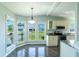 Cozy breakfast nook with large windows and plenty of natural light next to the kitchen at 1228 Maria Ct, Lady Lake, FL 32159