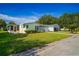 Charming single-story home with a well-manicured lawn and attached garage at 1228 Maria Ct, Lady Lake, FL 32159