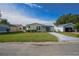Charming single-story home with a well-manicured lawn and a detached garage at 1228 Maria Ct, Lady Lake, FL 32159