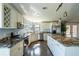 Kitchen with granite countertops, stainless appliances, wine rack, and plenty of counter space at 1228 Maria Ct, Lady Lake, FL 32159