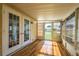 Sunroom with wood-look floors, a wall of windows and glass doors at 1228 Maria Ct, Lady Lake, FL 32159