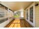 Sunroom with wood-look floors and a wall of windows and doors at 1228 Maria Ct, Lady Lake, FL 32159