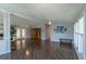 Open living room with hardwood floors and lots of natural light, open to kitchen and dining areas at 1228 Maria Ct, Lady Lake, FL 32159