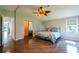 Spacious main bedroom featuring wood-look floors, ceiling fan, closet, and natural light at 1228 Maria Ct, Lady Lake, FL 32159