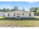A spacious backyard featuring a sliding glass door entrance and simple modern design at 12974 Se 42Nd Ct, Belleview, FL 34420