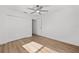 Bedroom featuring wood-look flooring, ceiling fan and closet at 12974 Se 42Nd Ct, Belleview, FL 34420