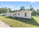 Bright single-story home featuring a well-maintained lawn and minimalist design at 12974 Se 42Nd Ct, Belleview, FL 34420