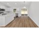 Modern kitchen featuring white cabinets, stainless steel appliances, and a large island at 12974 Se 42Nd Ct, Belleview, FL 34420