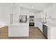 Bright, open kitchen with white cabinetry, stainless steel appliances, and a quartz island at 12974 Se 42Nd Ct, Belleview, FL 34420