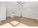 Bright, airy living space features modern wood-look floors, ceiling fan, and open concept design at 12974 Se 42Nd Ct, Belleview, FL 34420