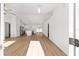 Bright, airy living space features modern wood-look floors, ceiling fan, and an open floorplan at 12974 Se 42Nd Ct, Belleview, FL 34420