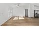 Bright living space with ceiling fan and hardwood floors, open to the adjacent kitchen at 12974 Se 42Nd Ct, Belleview, FL 34420
