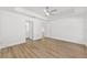 Bright main bedroom features wood-look flooring and a modern ceiling fan at 12974 Se 42Nd Ct, Belleview, FL 34420