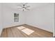 This bedroom features a ceiling fan, bright natural light, and wood-look flooring at 12988 Se 42Nd Ct, Belleview, FL 34420