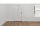 Bright entryway with a white front door and wood-look flooring at 12988 Se 42Nd Ct, Belleview, FL 34420