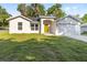 Charming single-story home featuring a bright yellow door and attached two-car garage at 12988 Se 42Nd Ct, Belleview, FL 34420