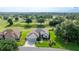 Well-maintained single-story home on golf course featuring mature landscaping and an attached two-car garage at 13015 Se 93Rd Cir, Summerfield, FL 34491