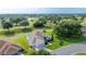 Single-story home with an attached two-car garage featuring mature landscaping and views of the golf course at 13015 Se 93Rd Cir, Summerfield, FL 34491