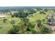 Scenic aerial view of a lush golf course community with mature trees and well-maintained lawns at 13015 Se 93Rd Cir, Summerfield, FL 34491