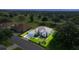 Stunning aerial view of home with manicured lawn, mature trees, and golf course in the background at 13015 Se 93Rd Cir, Summerfield, FL 34491