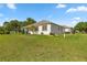 Expansive backyard with well-maintained lawn and a glimpse of the house exterior at 13015 Se 93Rd Cir, Summerfield, FL 34491
