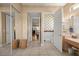 Hallway leading to a bathroom that features a toilet room and double doors for closet space at 13015 Se 93Rd Cir, Summerfield, FL 34491