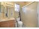 Bathroom featuring tile floors, a vanity with mirror, and a glass-enclosed shower at 13015 Se 93Rd Cir, Summerfield, FL 34491