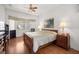 Sunlit bedroom with bay window, hardwood floors, and a classic wooden bed frame at 13015 Se 93Rd Cir, Summerfield, FL 34491