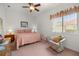 Bright bedroom with ceiling fan and a window letting in plenty of light at 13015 Se 93Rd Cir, Summerfield, FL 34491