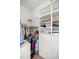 Walk-in closet offers ample storage with shelves, drawers, and clothing racks at 13015 Se 93Rd Cir, Summerfield, FL 34491