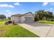 Detached two-car garage with an extended driveway and mature landscaping at 13015 Se 93Rd Cir, Summerfield, FL 34491