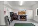 Organized garage with shelving, a workbench, and ample space for storage and projects at 13015 Se 93Rd Cir, Summerfield, FL 34491