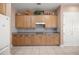 Bright kitchen featuring light wood cabinets, ample counter space, and stainless steel appliances at 13015 Se 93Rd Cir, Summerfield, FL 34491