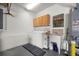 Functional laundry area equipped with a washer, dryer, utility sink, and storage cabinets at 13015 Se 93Rd Cir, Summerfield, FL 34491