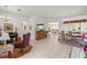 Open concept living room and dining area with tile flooring and large windows allowing lots of natural light at 13015 Se 93Rd Cir, Summerfield, FL 34491