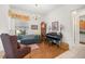Cozy living room features a comfortable blue sofa and a classic grandfather clock at 13015 Se 93Rd Cir, Summerfield, FL 34491