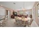 Open-concept living area with dining table, comfortable seating, and abundant natural light at 13015 Se 93Rd Cir, Summerfield, FL 34491