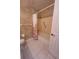 Neutral bathroom with patterned wallpaper, shower/tub combo, and tiled floor at 13385 Ne 10Th Ct, Citra, FL 32113