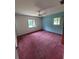 Spacious bedroom with neutral walls, carpet floor and windows with outdoor views at 13385 Ne 10Th Ct, Citra, FL 32113