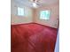 Comfortable bedroom featuring neutral walls, ceiling fan, and natural light at 13385 Ne 10Th Ct, Citra, FL 32113