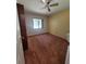 Sunny bedroom featuring neutral walls, ceiling fan, and natural light at 13385 Ne 10Th Ct, Citra, FL 32113