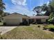 Charming single-story home with a well-maintained lawn and attached two-car garage at 13385 Ne 10Th Ct, Citra, FL 32113